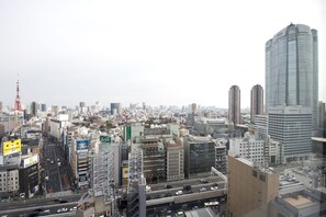 A cityscape with high-rise buildings, busy streets, and a prominent tower.