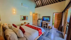 Un dormitorio con cama, escritorio, televisor y armario.