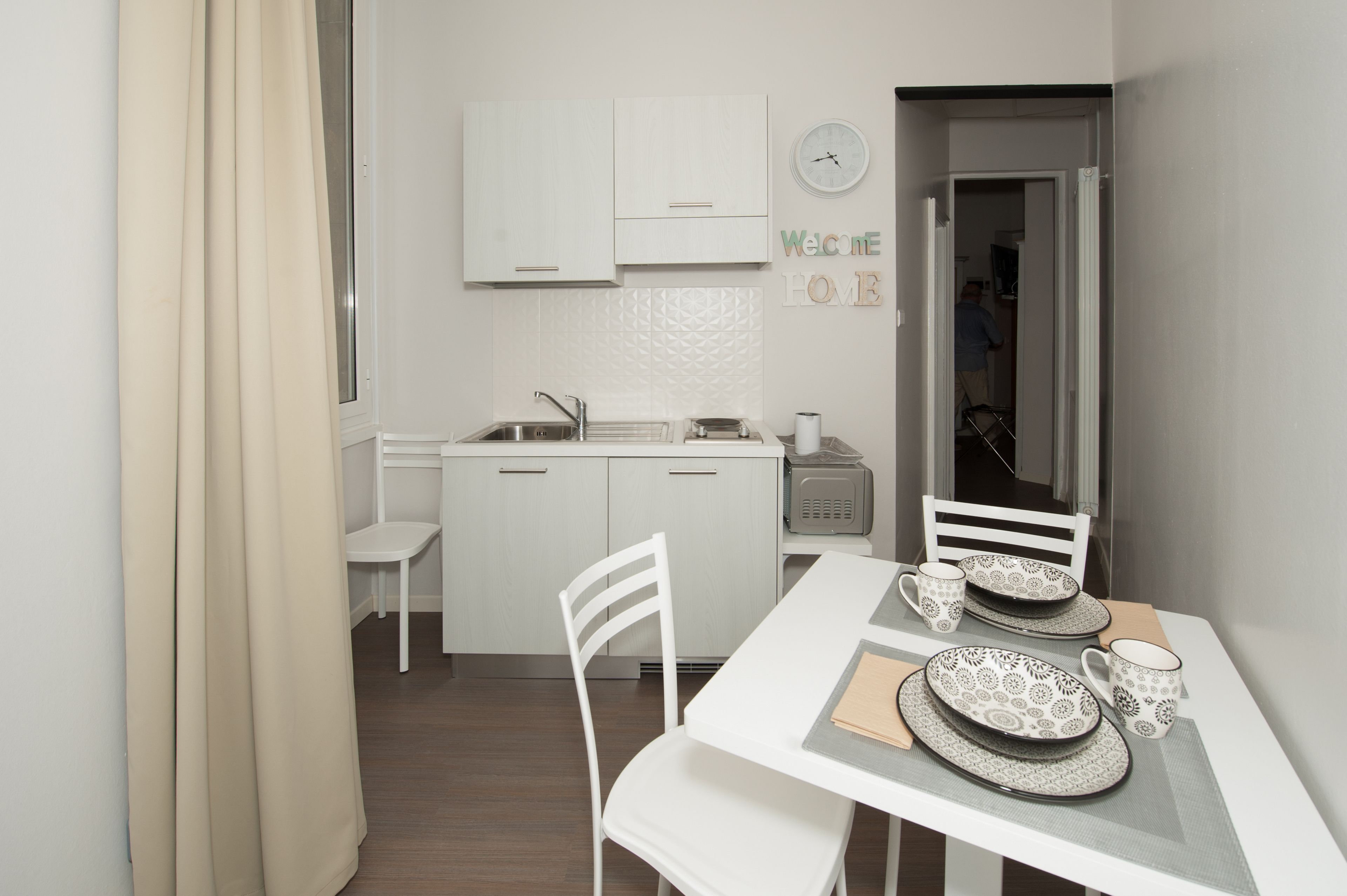 mini-fridge, stovetop, coffee grinder, cookware/dishes/utensils