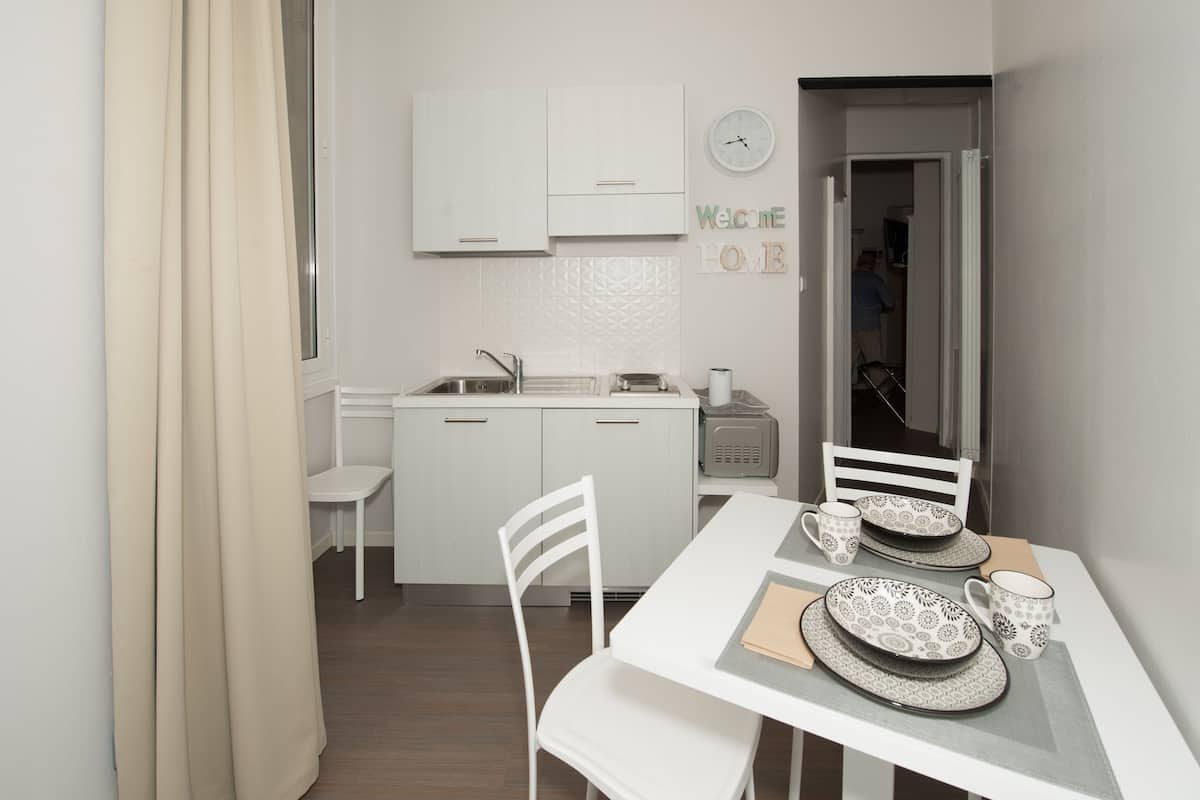 mini-fridge, stovetop, coffee grinder, cookware/dishes/utensils