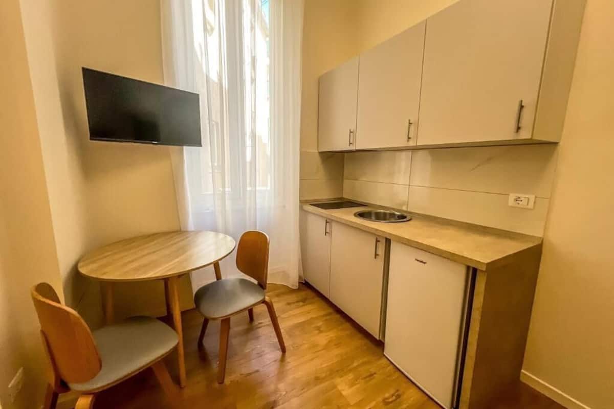 mini-fridge, stovetop, coffee grinder, cookware/dishes/utensils