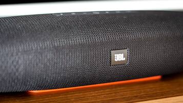 A close-up of a JBL speaker with a textured surface and a visible JBL logo.