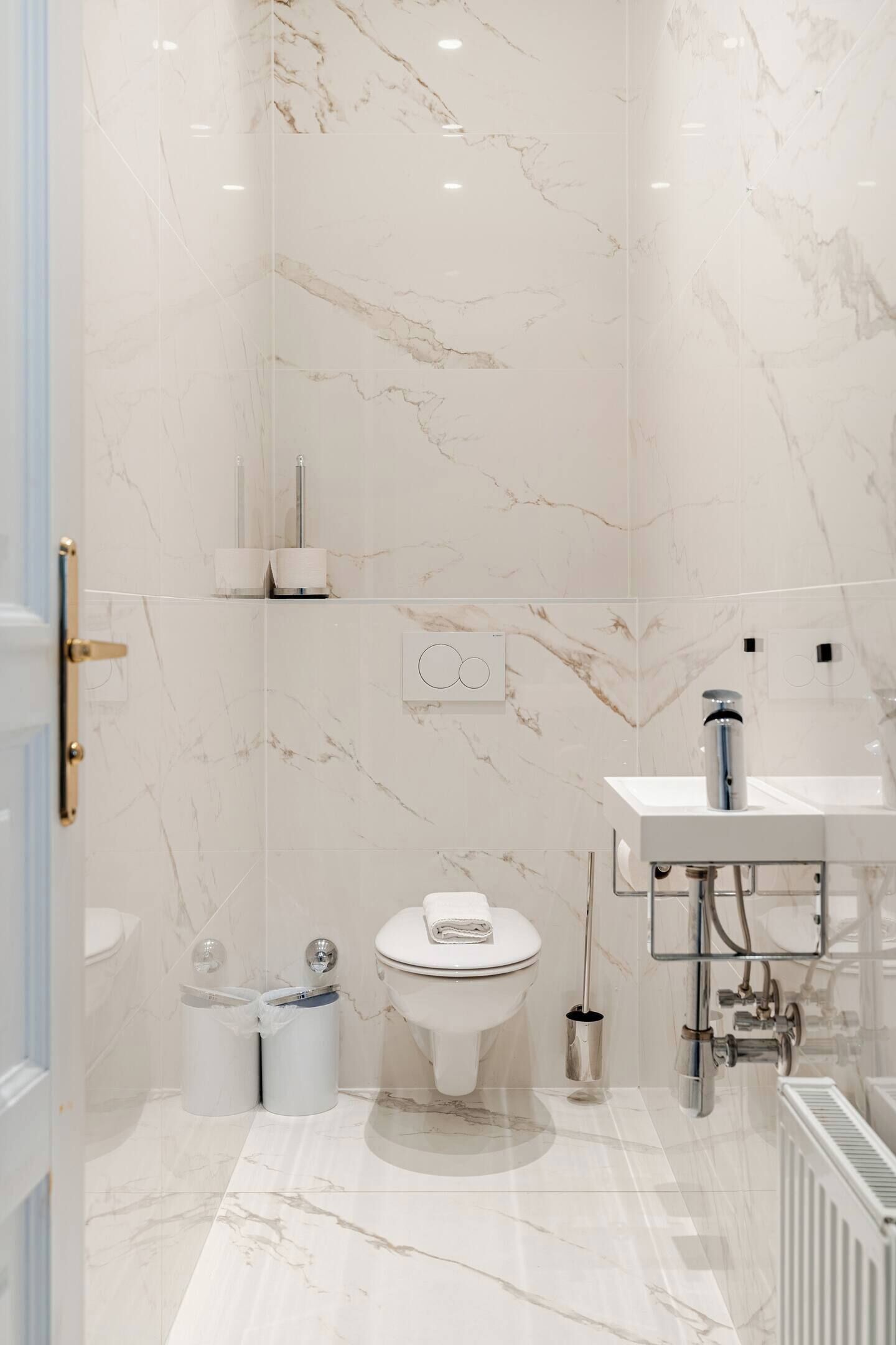 A modern bathroom with a toilet, bidet, and sink.