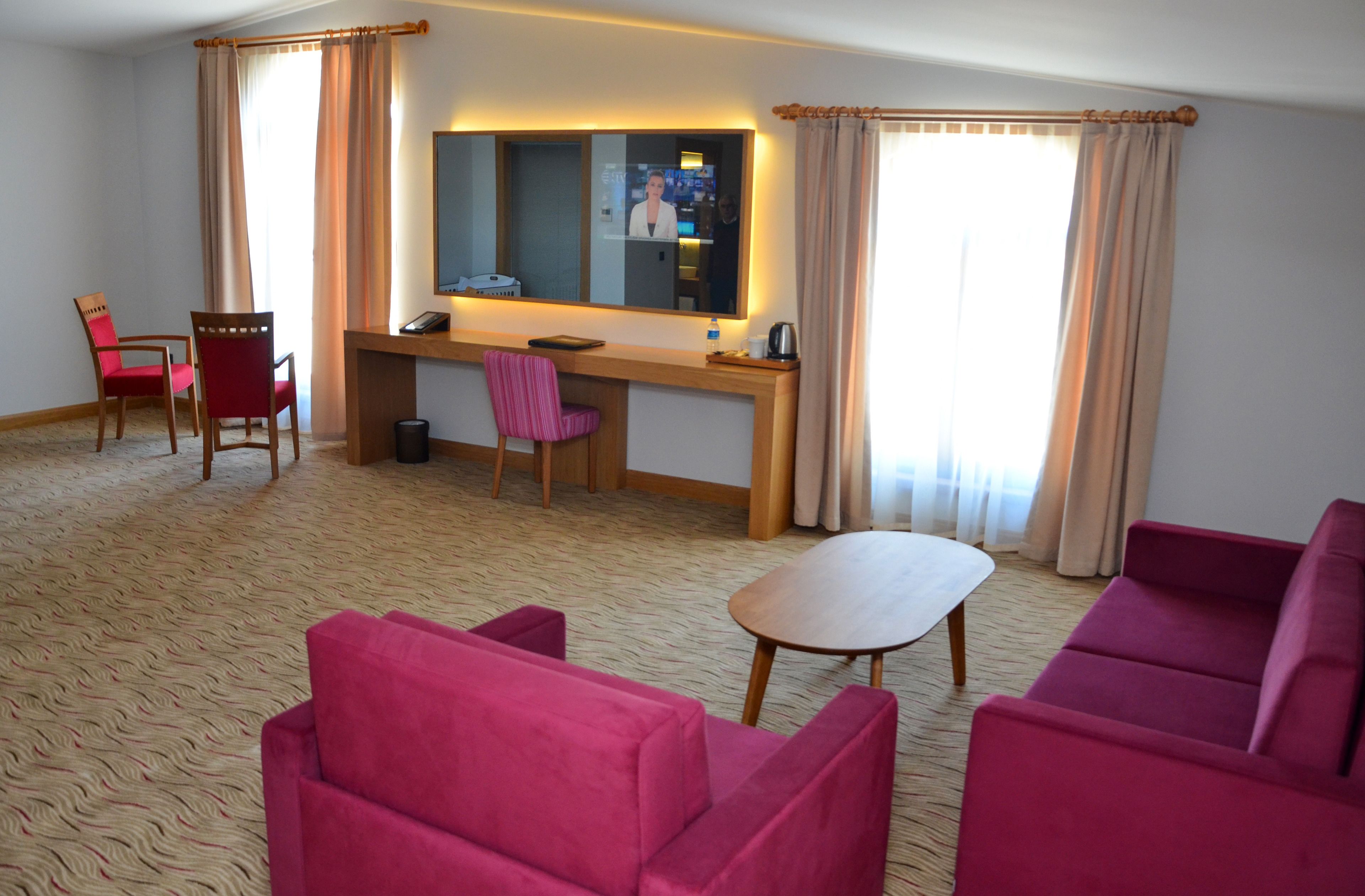 deluxe quadruple room | living area | 32-inch lcd tv with satellite channels, tv