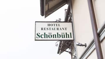 A sign for a hotel restaurant named 'Schönbühl'.