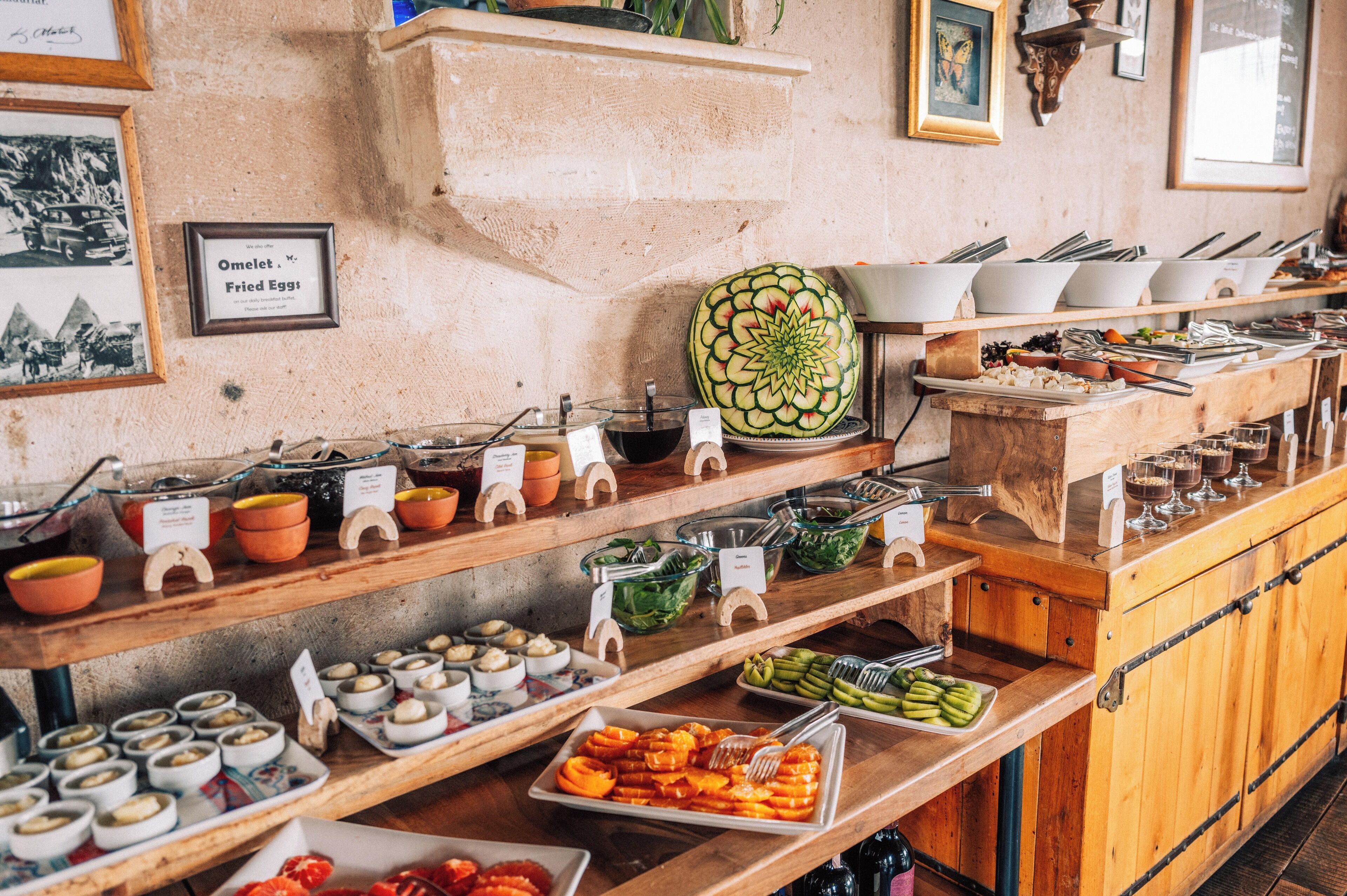 A buffet with various food items and utensils.