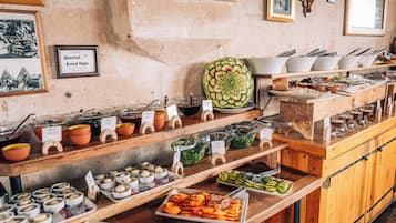 A buffet with various food items and utensils.