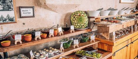 A buffet with various food items and utensils.