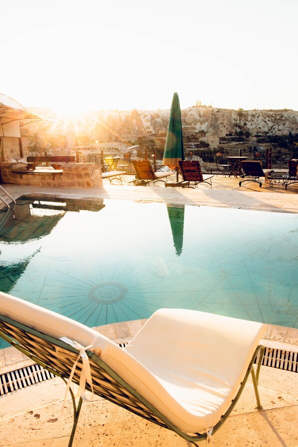 Seasonal outdoor pool, open 10:00 AM to 7:30 PM, pool umbrellas