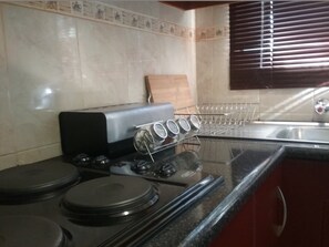 Full-sized fridge, microwave, stovetop, coffee/tea maker