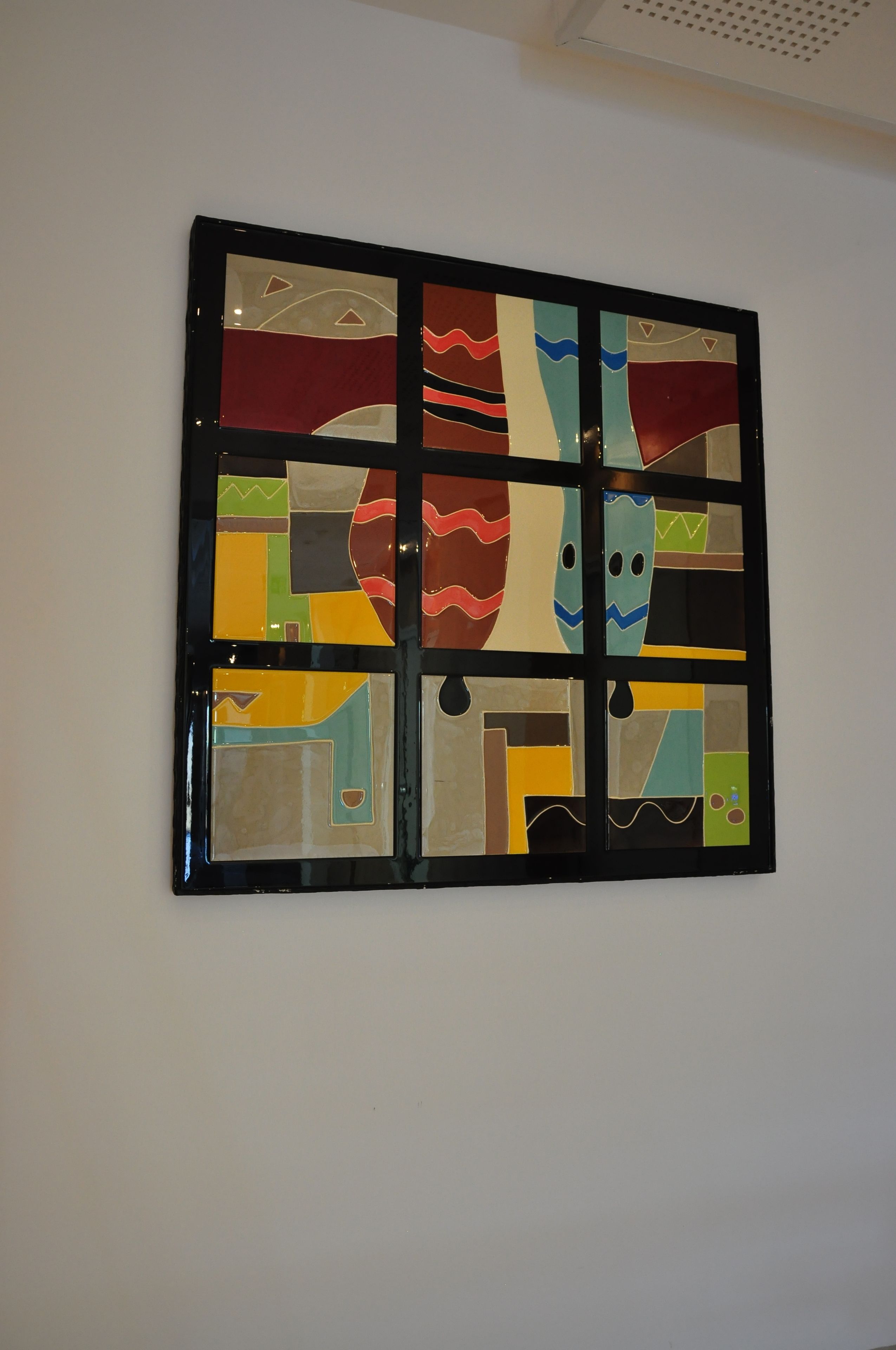 Un'opera d'arte astratta a parete con forme geometriche e linee.
