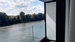 A balcony with a view of a river and trees. - Hôtel de la seine (Epinay-sur-Seine)