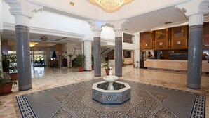 A spacious lobby with a central fountain, marble flooring, and ornate columns. - Hotel Riviera - Family Only (Port El Kantaoui)