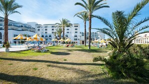 A resort with a pool area, sun loungers, and palm trees. - Hotel Riviera - Family Only (Port El Kantaoui)