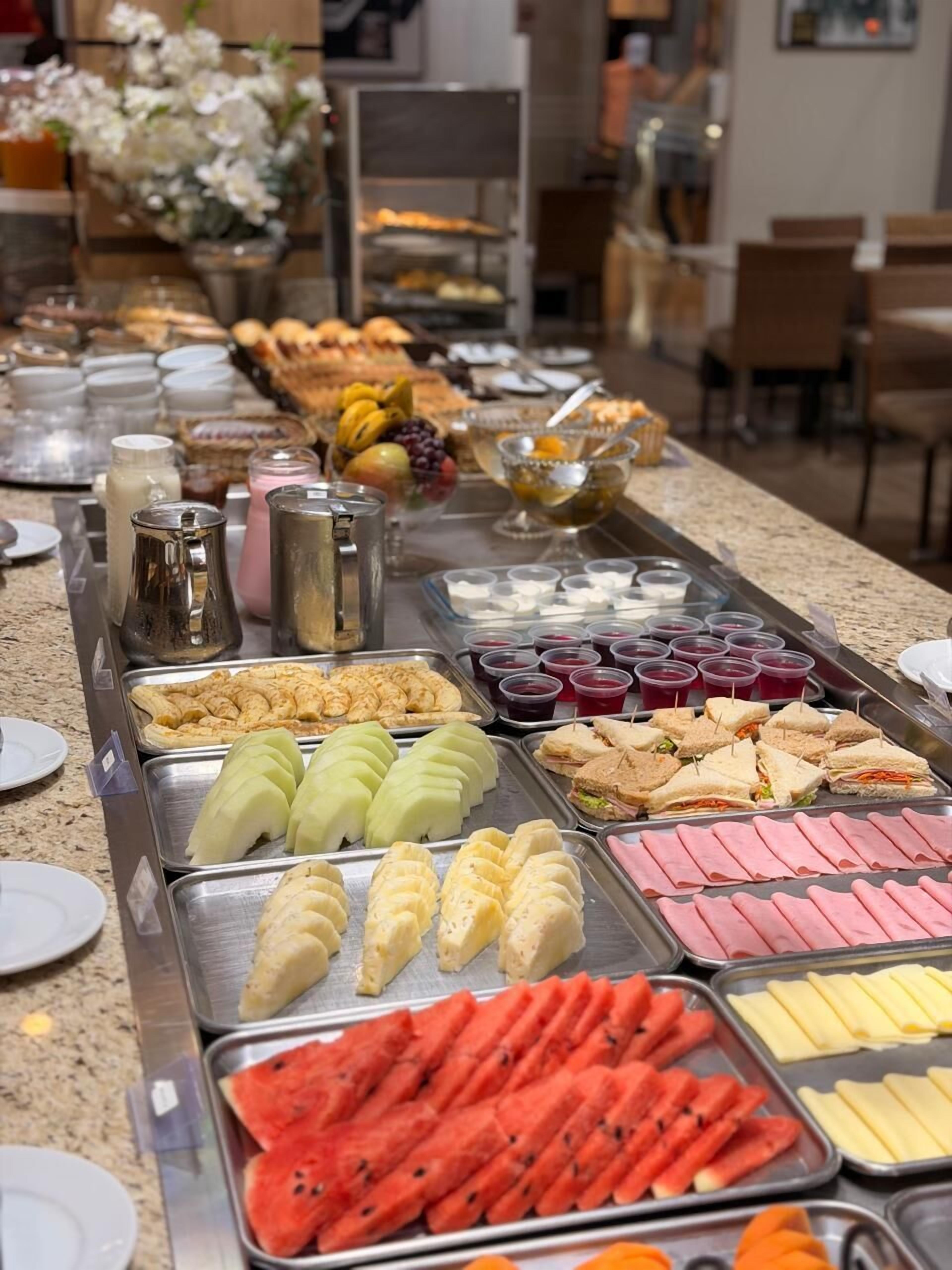 A buffet with various food items and beverages.