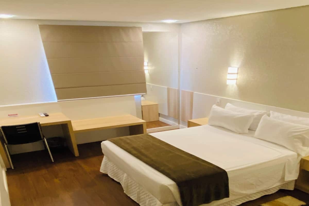 Deluxe Double Room | Minibar, in-room safe, desk, blackout drapes