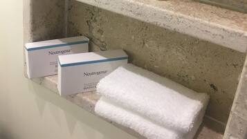 A shelf with Neutrogena products including shampoo, body lotion, and conditioner.