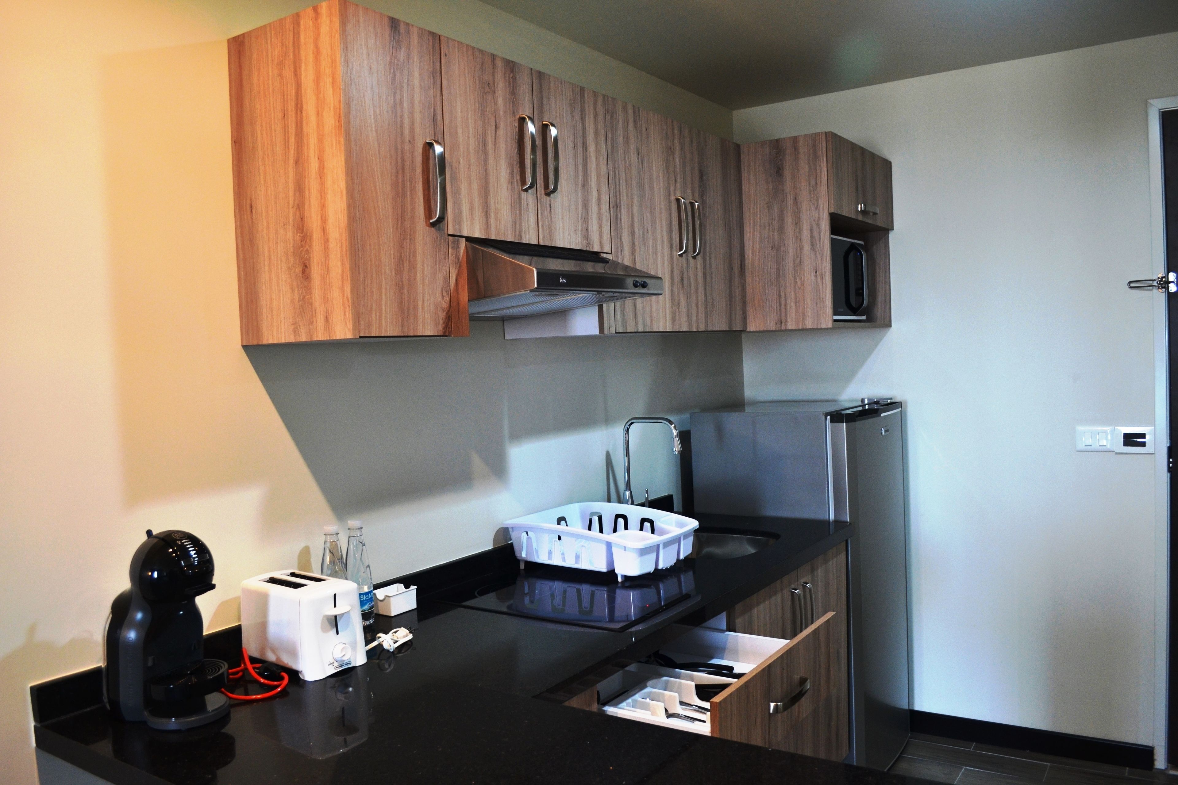 suite, 1 king bed, non smoking, refrigerator | private kitchen | fridge, coffee/tea maker