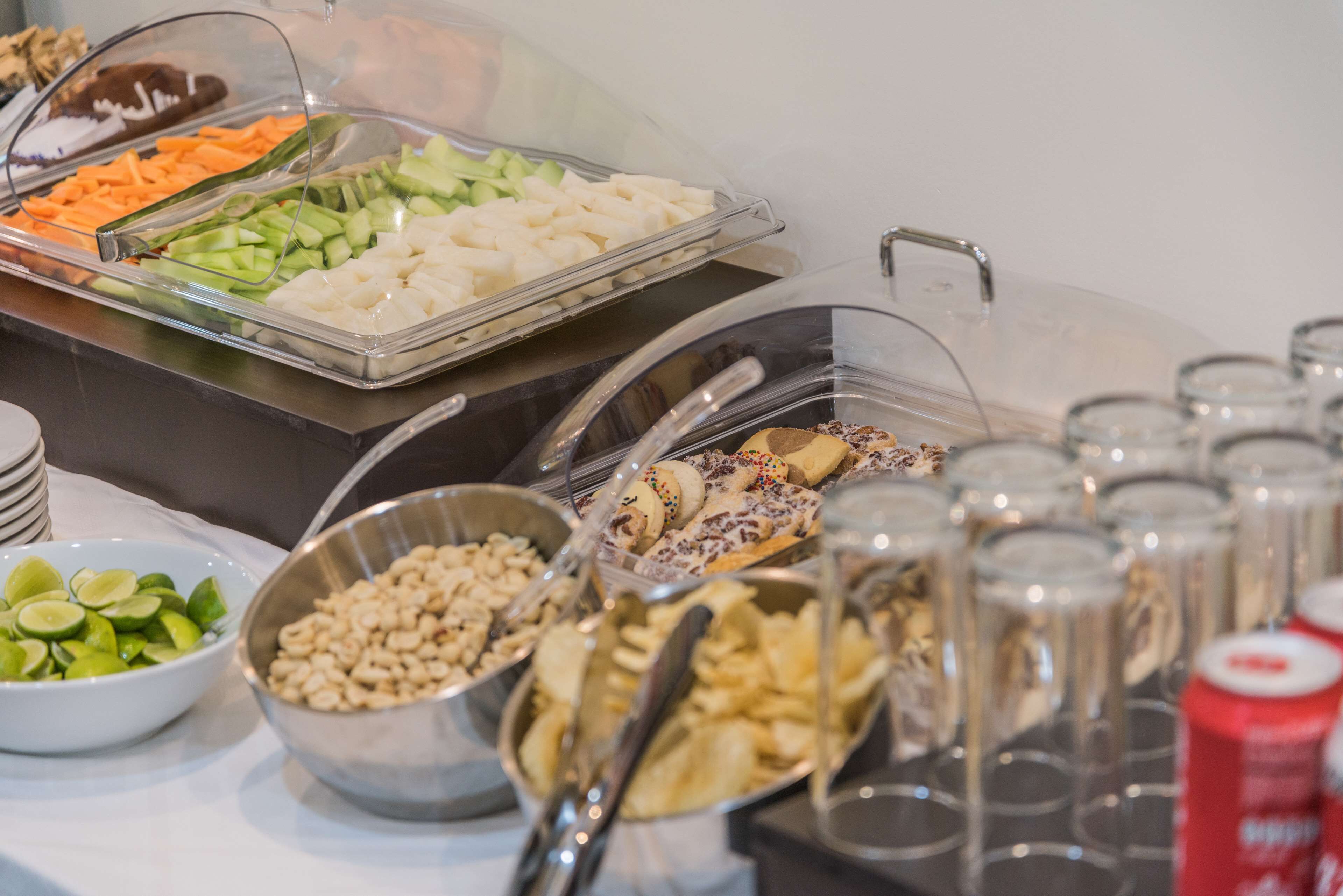A buffet with various food items and beverages.