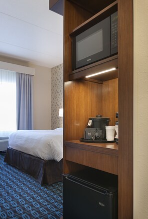 A hotel room with a bed, a microwave, a refrigerator, and a coffee maker on the counter. - Fairfield Inn & Suites Rock Hill (Rock Hill)