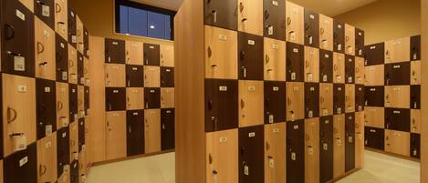 A row of lockers with numbers on them, arranged in a hallway.