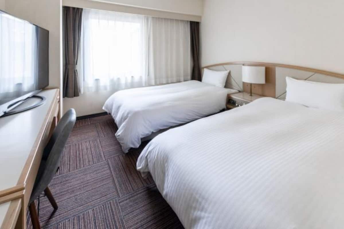 Desk, laptop workspace, blackout drapes, iron/ironing board