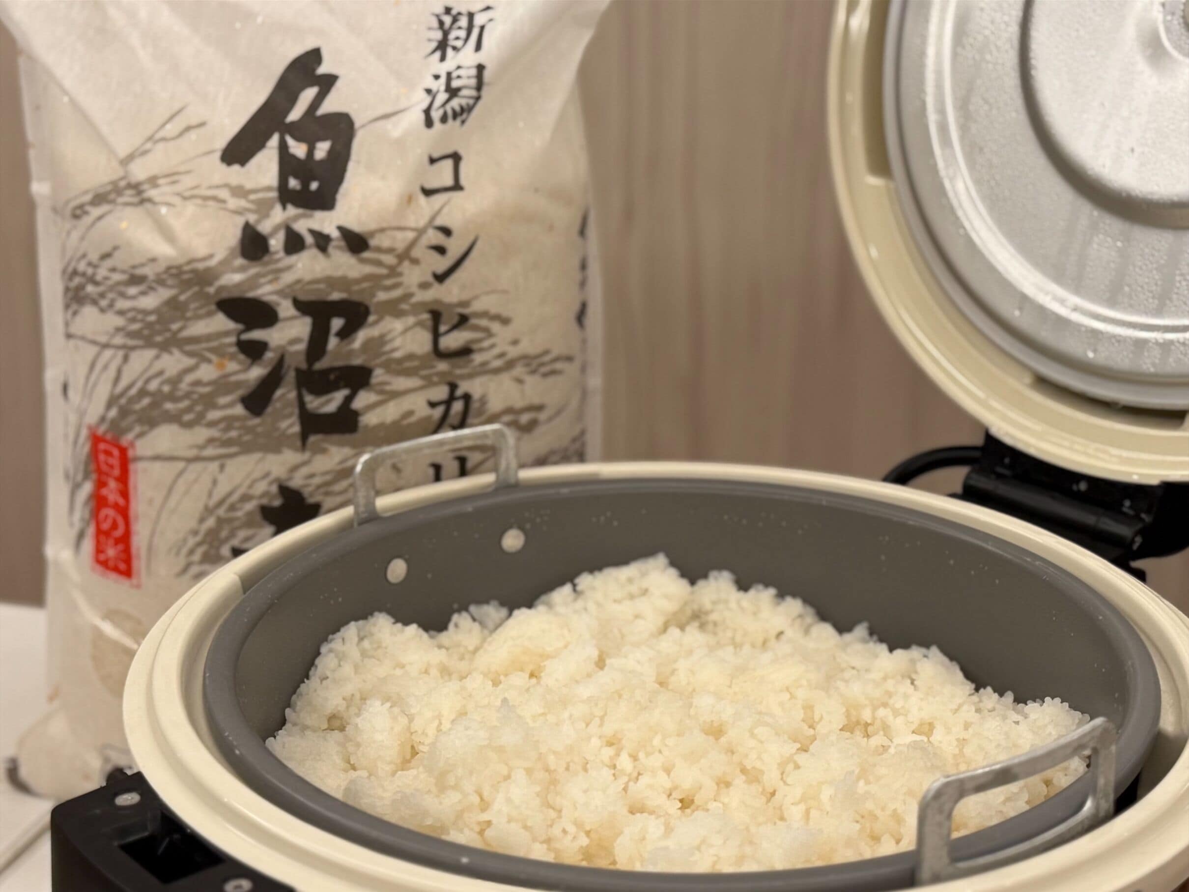 A rice cooker with cooked rice inside.