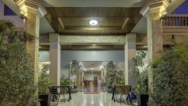 A spacious lobby with a high ceiling, marble columns, and a central light fixture. There are potted plants and seating areas. - DV Angkor Villa (Siem Reap)