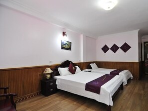 A hotel room with two beds, a nightstand, a lamp, and a framed picture on the wall. - Ngan Nga Bac Ha Hotel (Bac Ha)