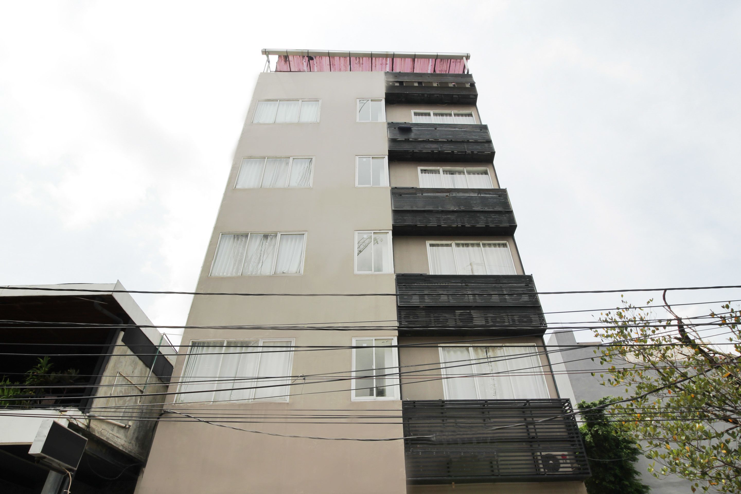 A multi-story building with balconies and windows.