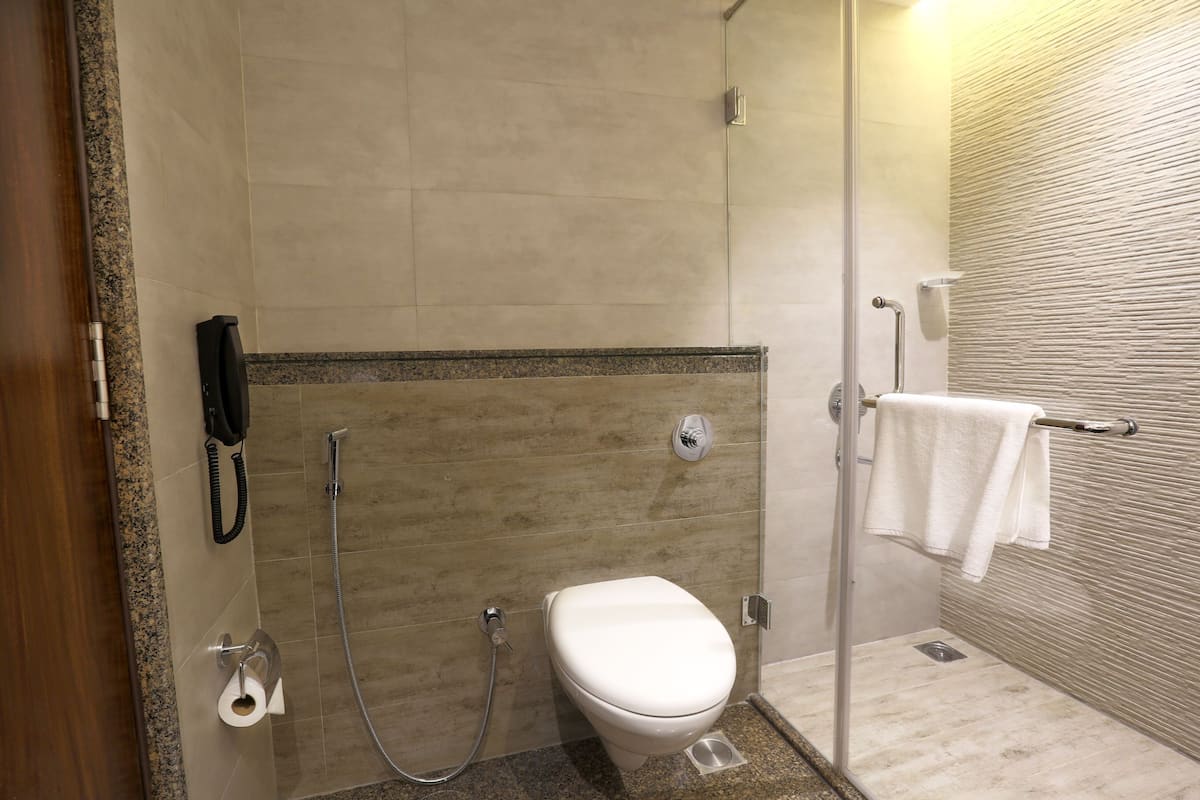 deluxe room | bathroom | shower, free toiletries, bathrobes, slippers