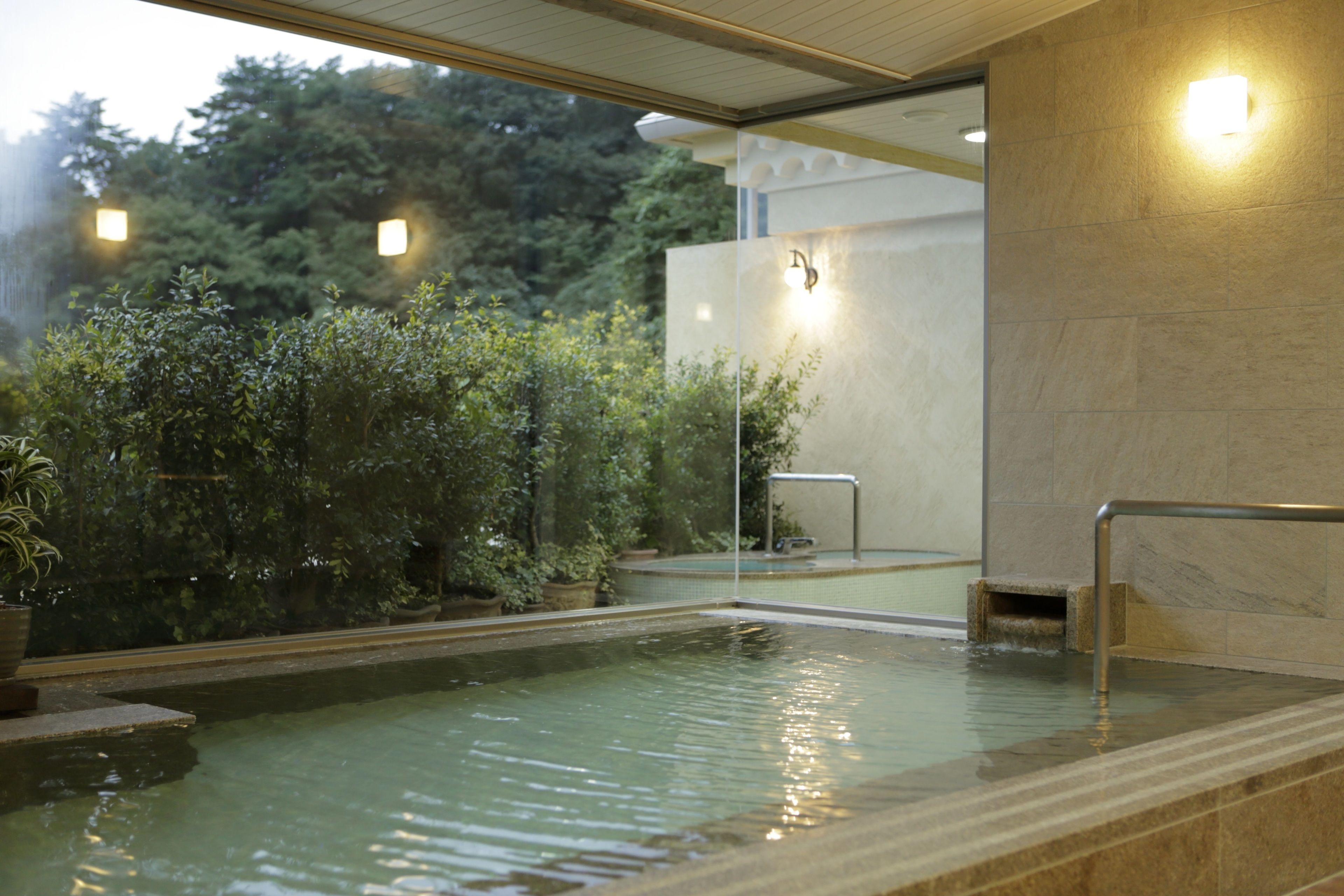 A spa pool with a clear view of the surrounding greenery and a modern architectural design.