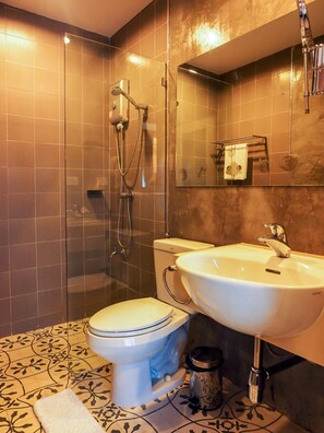 A bathroom with a toilet, sink, and shower. - Dejamoon (Chiang Mai)