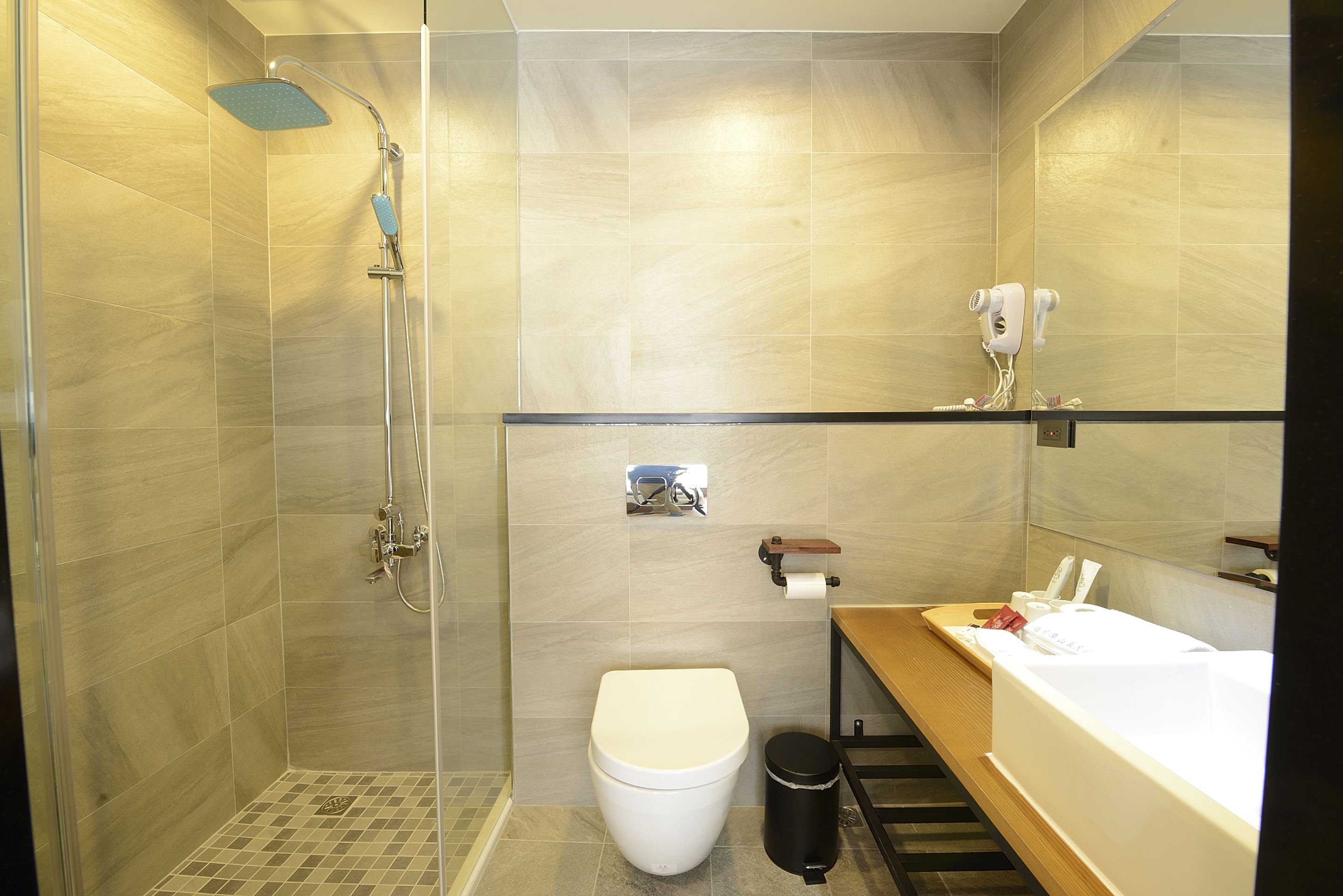 A modern bathroom with a shower, toilet, and bathtub.