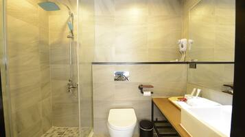 A modern bathroom with a shower, toilet, and bathtub.