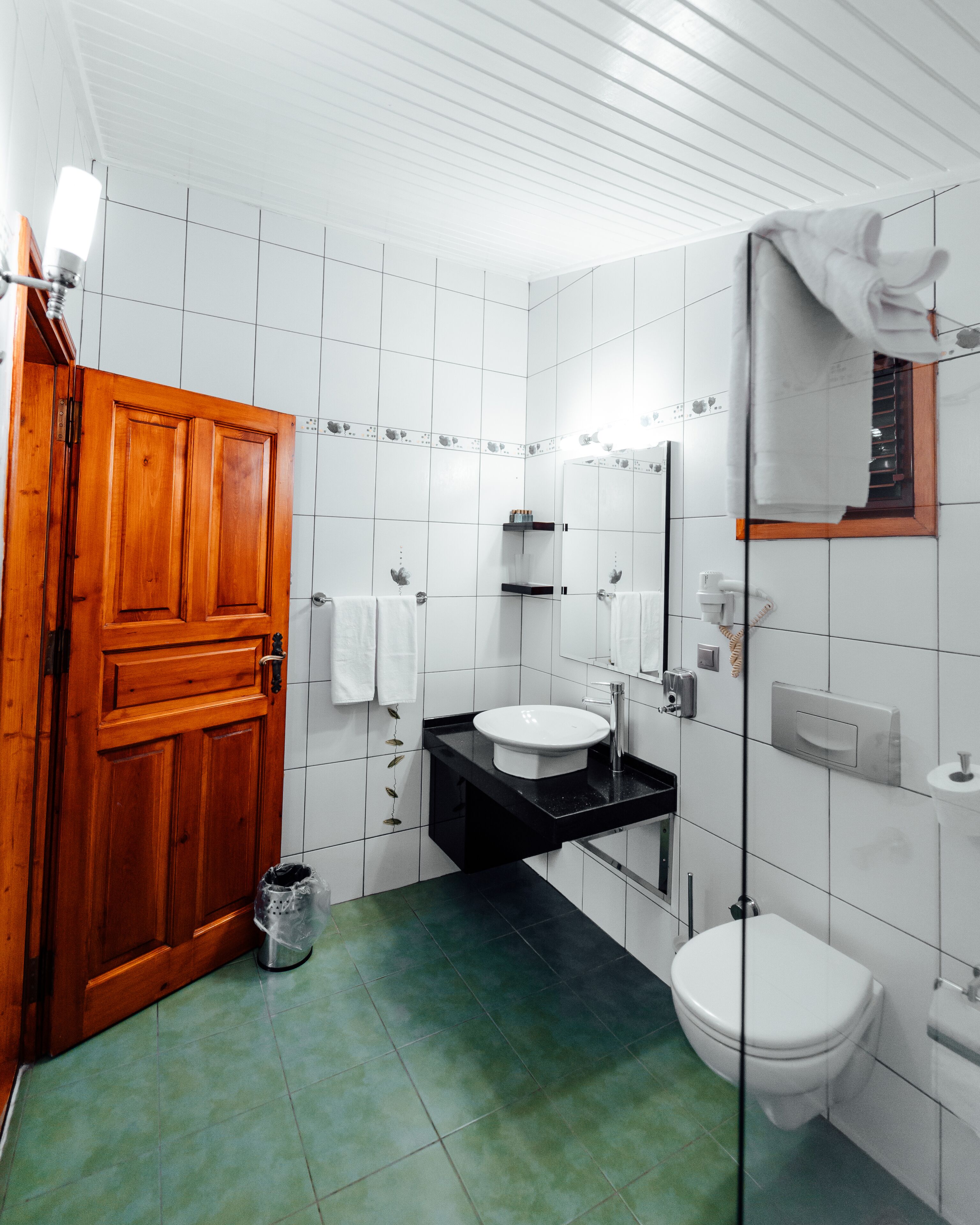 shower, hair dryer, slippers, towels