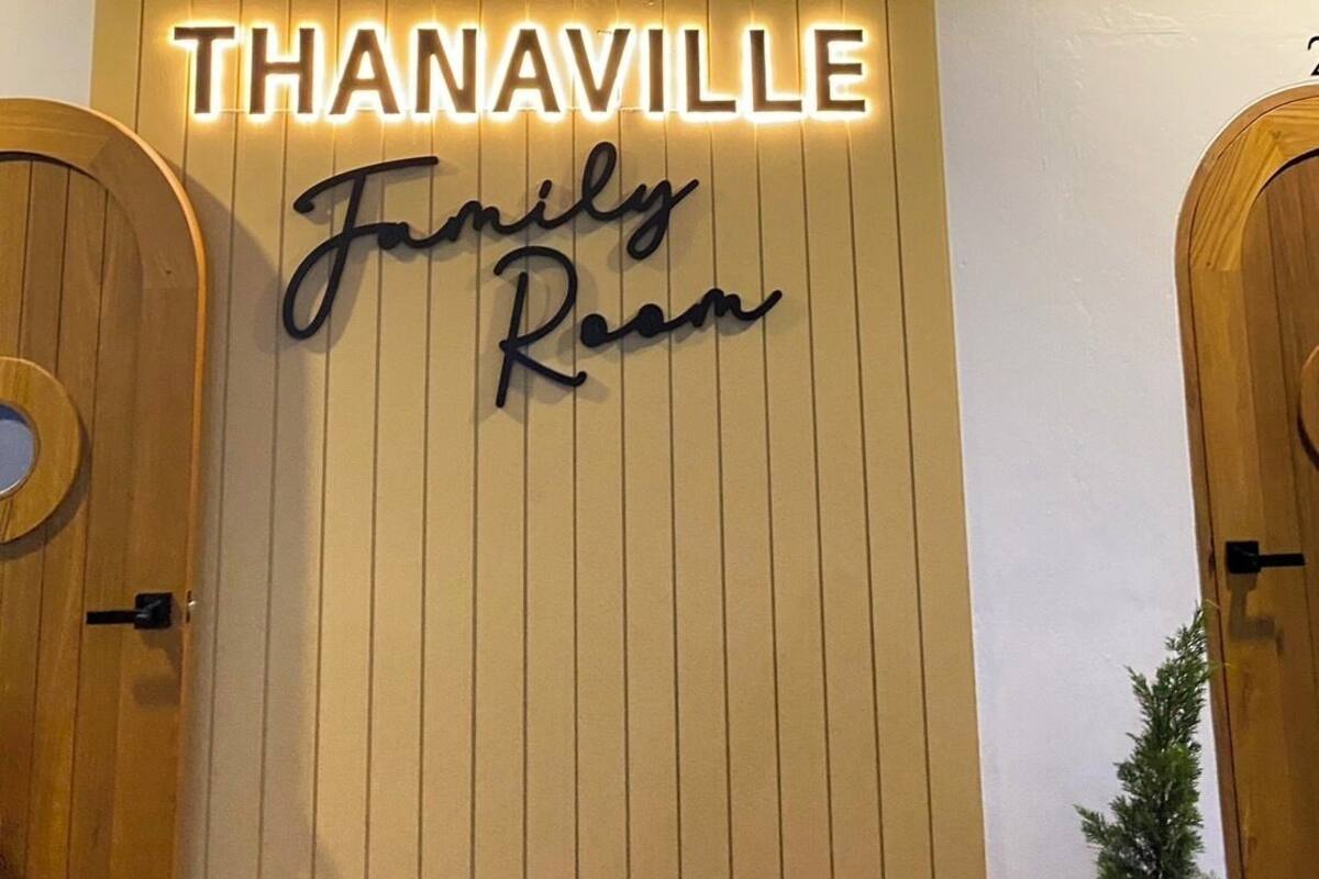 A hotel entrance with a sign reading "THANAVILLE Family Room".