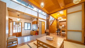 A traditional Japanese-style room with tatami flooring, a low wooden table, and a sliding door. - Suehirodori Japanese Entire Home No1 (Tainan)