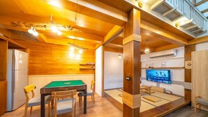 A cozy room with a pool table, wooden ceiling, and a television. - Suehirodori Japanese Entire Home No1 (Tainan)
