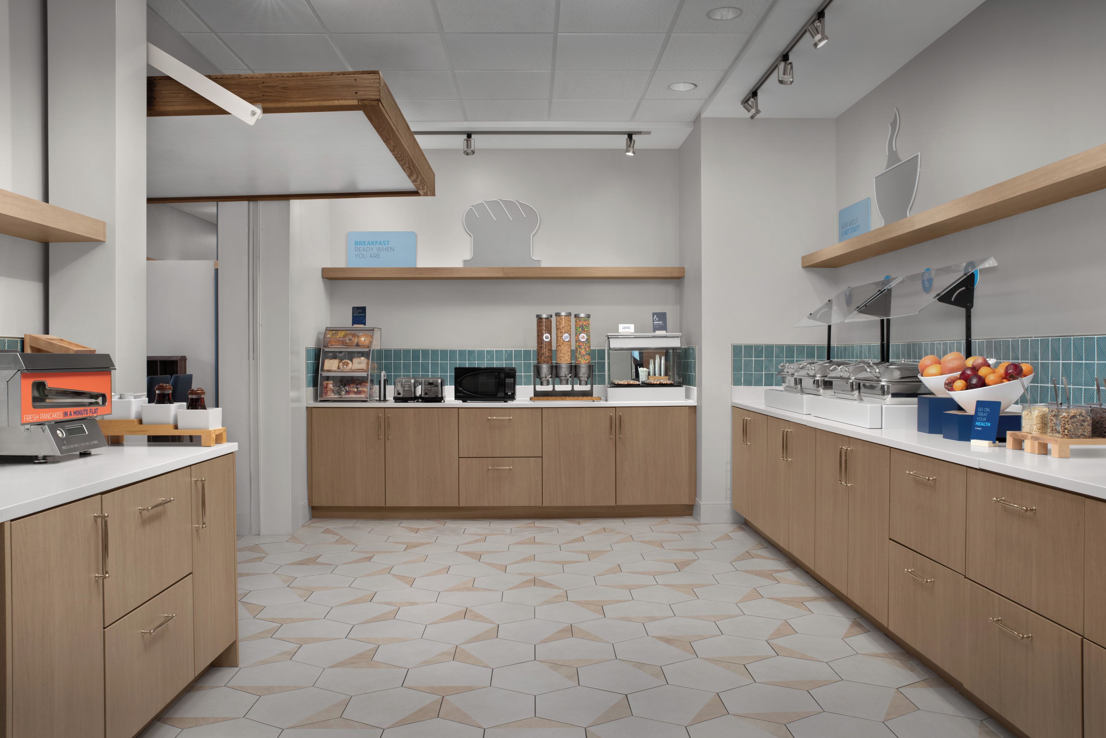 A modern kitchen with wooden cabinets, a microwave, and a breakfast bar.