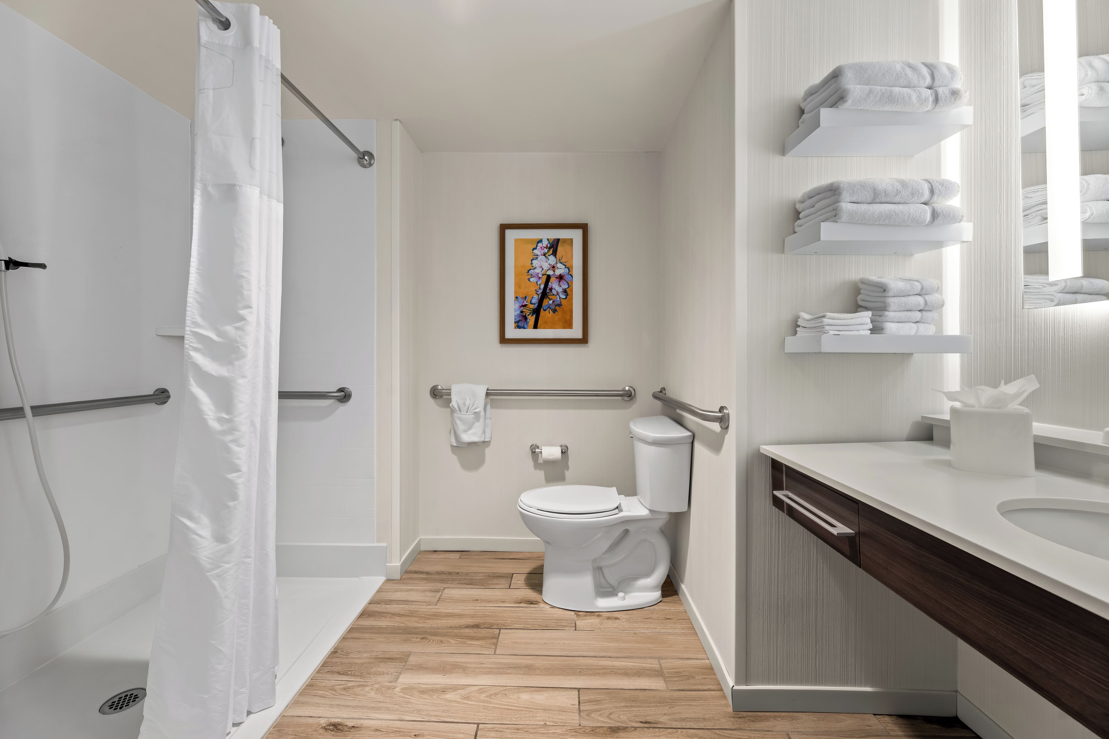 A modern bathroom with a shower, toilet, and sink.