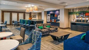 A hotel lobby with a bar area, seating arrangements, and a coffee station. - Hampton Inn Paragould (Paragould)
