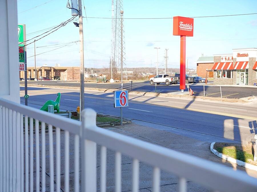 A street view with a gas station, a 'No Parking' sign, a 'No U-turn' sign, and a restaurant named 'Freddy's Steakhouse.'