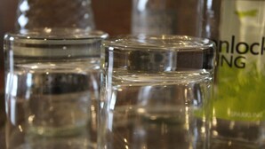 A close-up of three clear glass bottles with labels, one of which reads "Sparkling." - Red Dragon Inn (Carnforth)