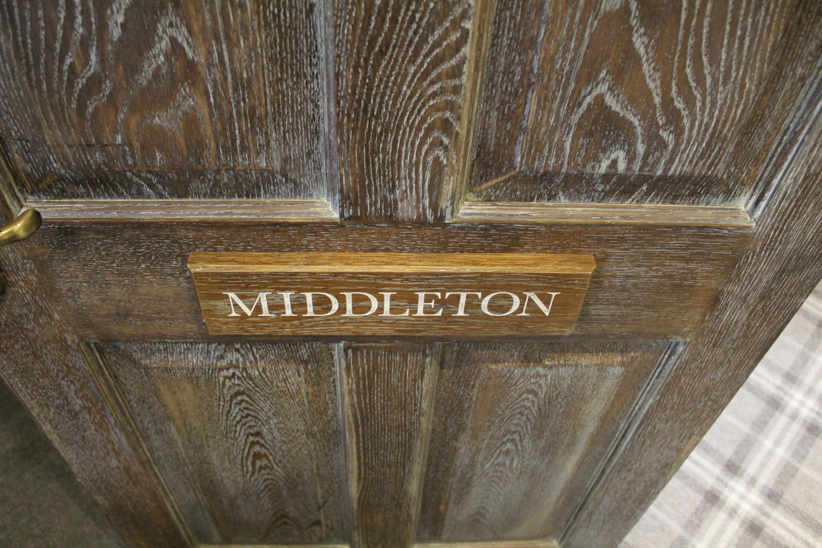A wooden door with a sign that reads "MIDDLETON".