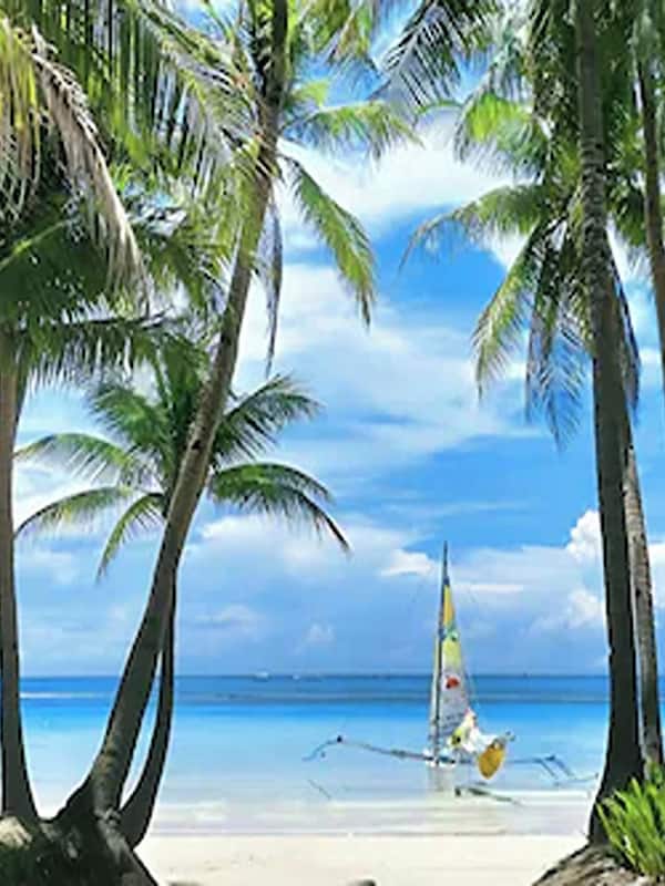 On the beach, white sand, sun loungers, beach umbrellas