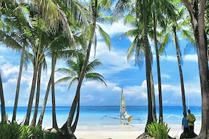 On the beach, white sand, sun-loungers, beach umbrellas