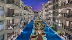 A multi-story hotel with a central swimming pool, balconies, and outdoor seating areas. - Henann Prime Beach Resort (Boracay Island)