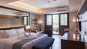 A modern hotel room with a large bed, a desk, and a seating area. - Henann Prime Beach Resort (Boracay Island)