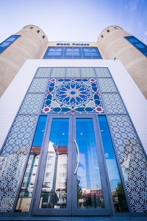 A building with a large glass facade and intricate geometric patterns.